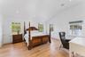 Bedroom featuring lofted ceiling, light wood finished floors, recessed lighting, and multiple windows.