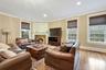 Living room with a fireplace, light hardwood / wood-style flooring, and ornamental molding