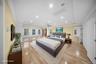 Bedroom featuring light wood finished floors, recessed lighting, and crown molding