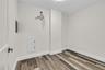 Spare room featuring baseboards and wood finished floors