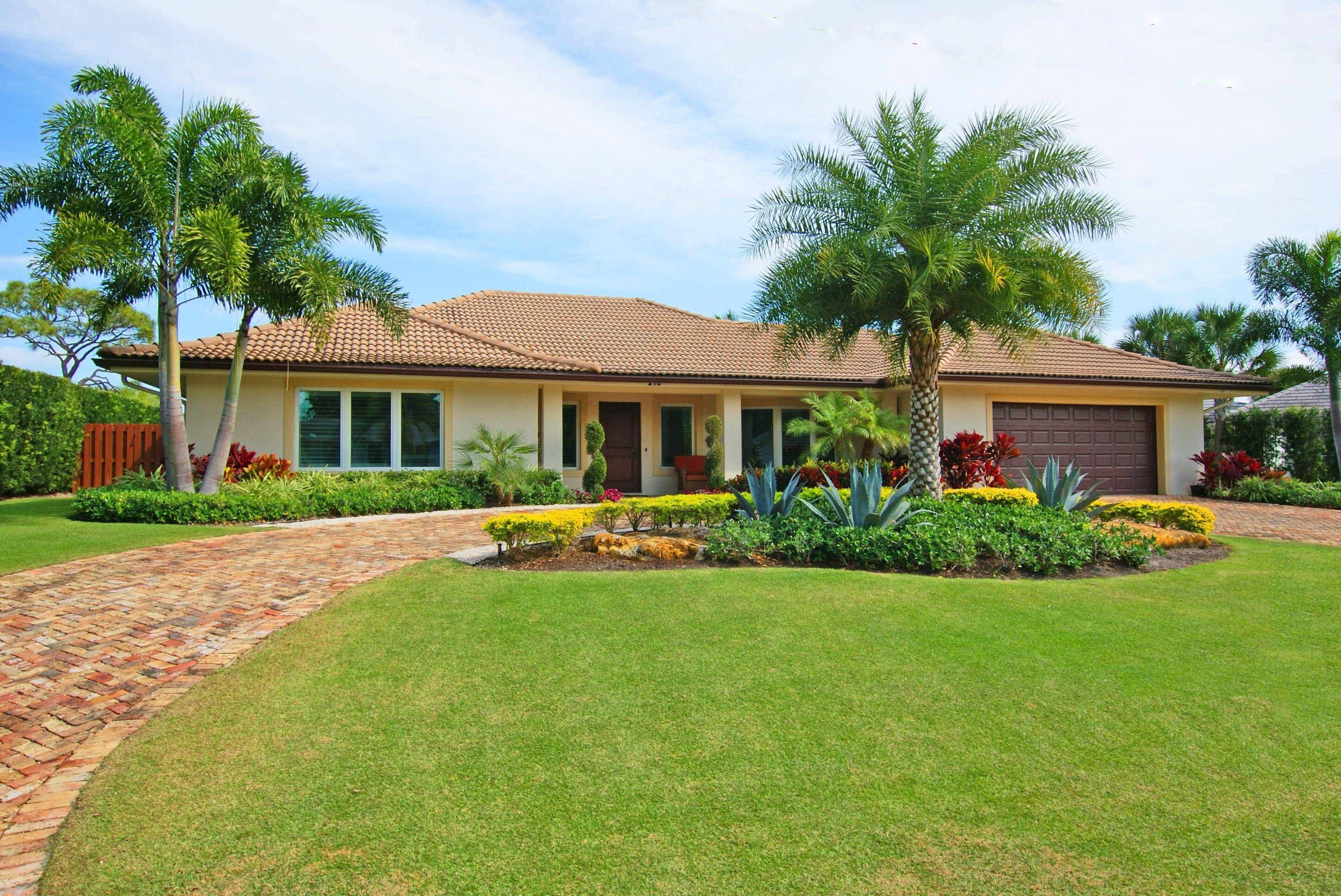 Stunning golf course home in Tequesta Country Club with beautiful, easterly golf course view !