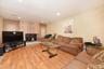 Living room featuring a baseboard heating unit and light hardwood / wood-style flooring