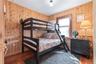 Bedroom with wooden walls and wood finished floors