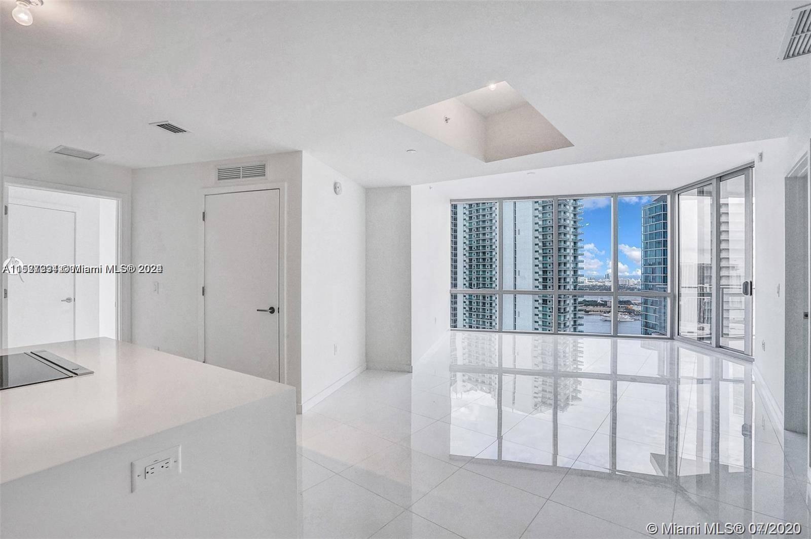 Welcome to the absolute most stunning 2bed 3bath den with direct water view on one of the highest floors with rare huge wrap around terrace at Paramount Miami.