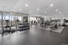 Workout area with floor to ceiling windows and recessed lighting