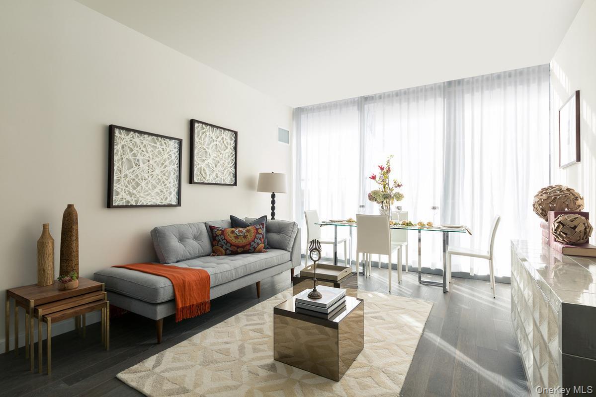 Living room with floor to ceiling windows and a wealth of natural light
