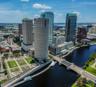Downtown Tampa Skyline next to Hillsborough River. Rivergate building in front next to Riverwalk.