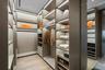 Spacious closet featuring light wood-style flooring