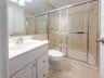 Full bathroom with vanity, a shower stall, and light tile patterned floors