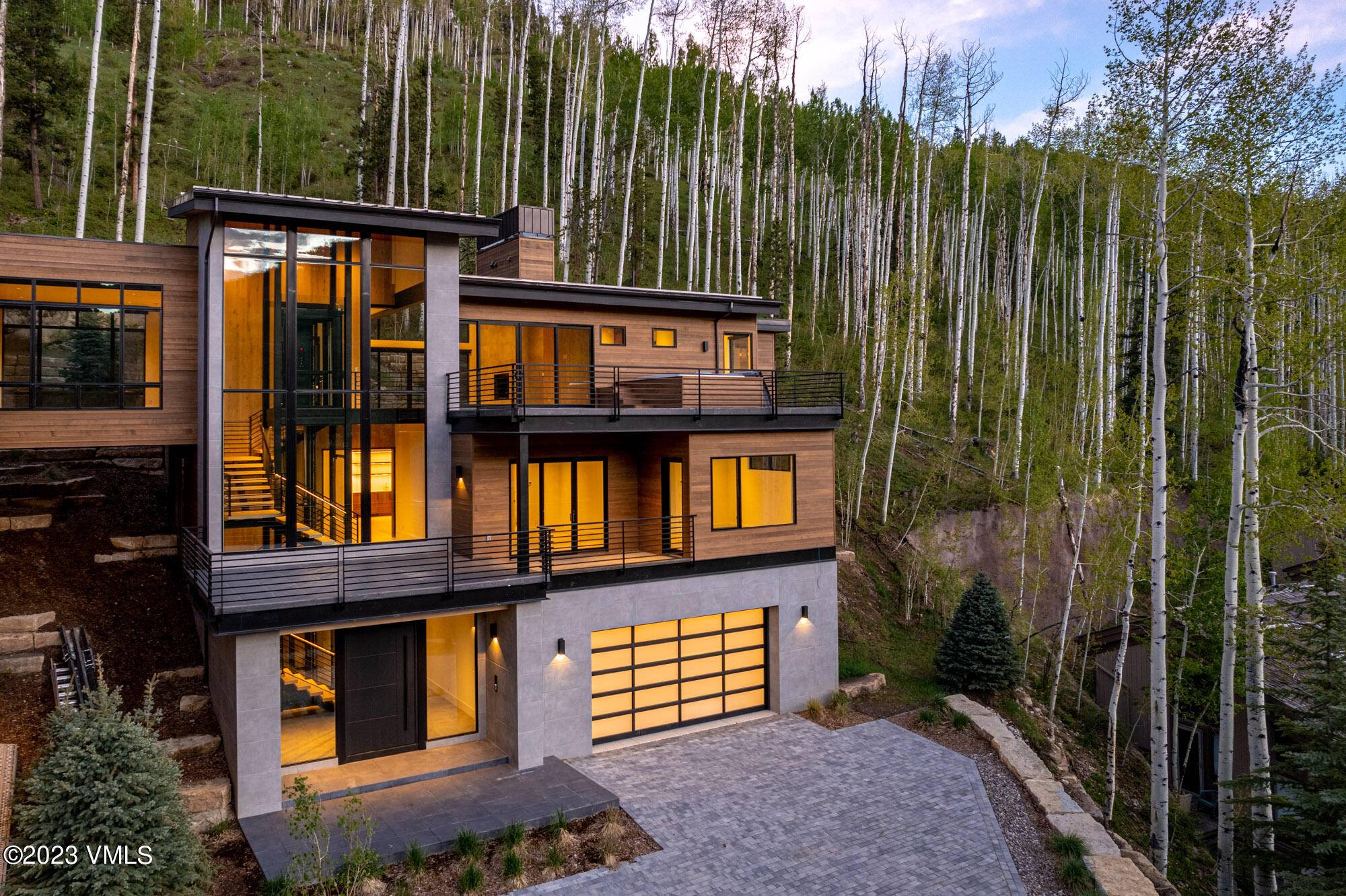 Located atop the coveted Cascade Village, 1469 Greenhill Court West is the large side of a mountain modern hillside oasis.