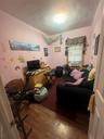 Office area featuring crown molding, dark wood finished floors, and radiator heating unit