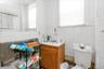 Bathroom with vanity, tile walls, and toilet