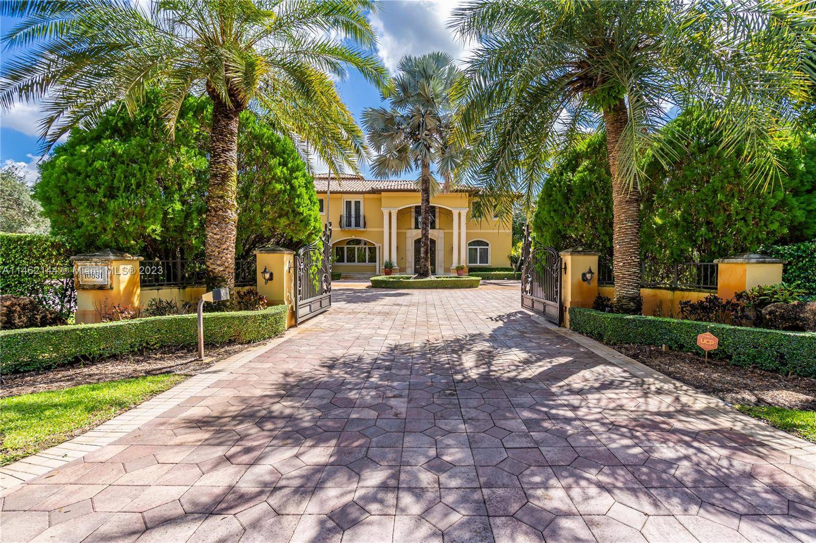 Situated in Pinecrest, this opulent home spans nearly an acre, offering 6 bedrooms, 6.