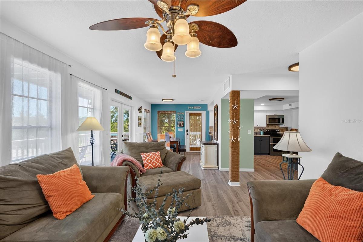 Alternate view of the living room flowing into the dining and kitchen areas.