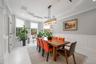 Dining space featuring a decorative wall, wainscoting, ornamental molding, recessed lighting, and a chandelier
