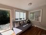 Sitting room featuring wood finished floors and cooling unit