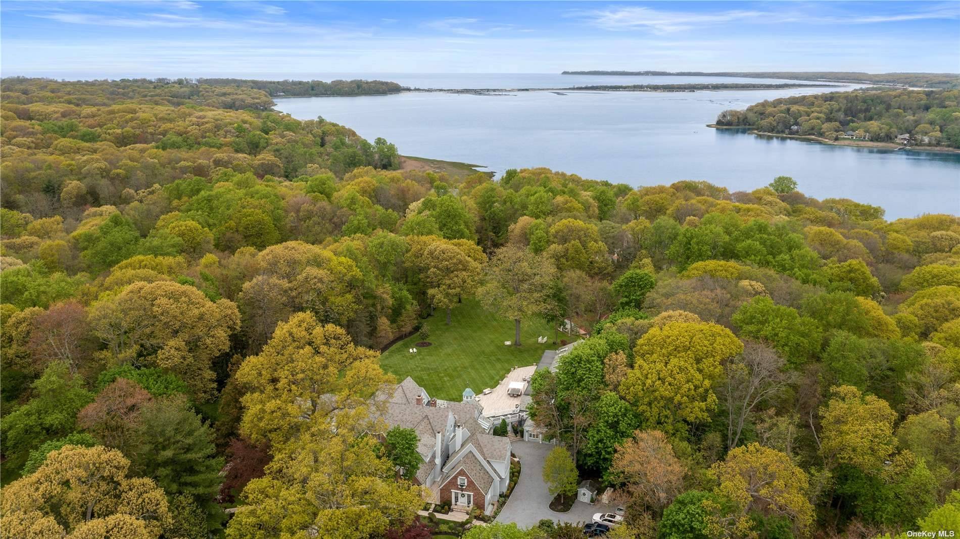SWAN MANOR ! Perfectly Situated On Just Over Nine Lush Private Acres In The Heart Of Nissequogue Lies This Magnificent Gated Estate With Grand Scale Elegance.