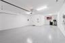 Spacious garage with golf cart parking and epoxy flooring