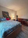 Bedroom with dark wood-type flooring
