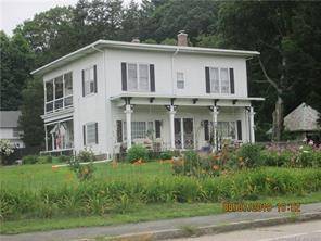 Stately, updated vintage colonial with 4 room rental apartment on nicely landscaped corner lot.