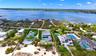 Aerial perspective of suburban area featuring a nearby body of water
