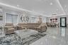Expansive open concept living area featuring large polished tile flooring, recessed, and cove ceiling lighting, and ceiling crown and floor molding