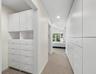 Tremendous storage room awaits in these two walk-in closets with built ins.