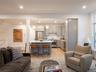 Living room with light wood-type flooring and recessed lighting