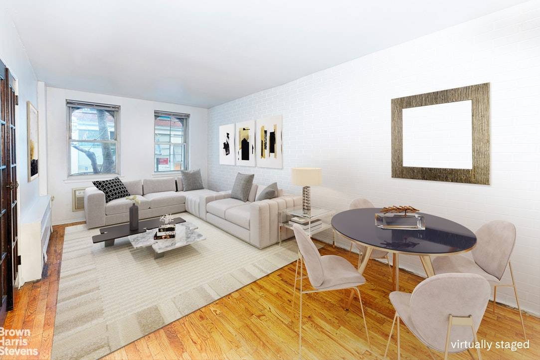 This charming one bedroom apartment has a great layout, street views, updated kitchen with pass through, hardwood floors, and through the wall a c.