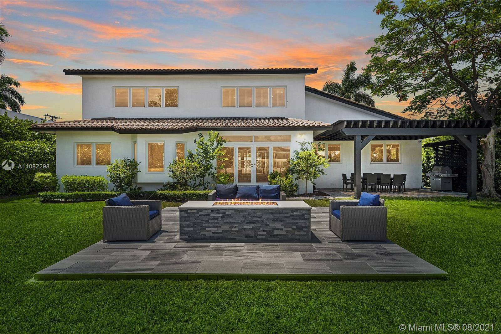 TWO STORY WATERFRONT VILLA WITH A GORGEOUS POOL, STUNNING FIREPIT AND PERGOLA COVERED ENTERTAINING SPACE.