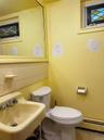 Half bathroom featuring tasteful backsplash, a baseboard heating unit, tile patterned floors, and tile walls