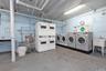 Community laundry with stacked washing machine and dryer