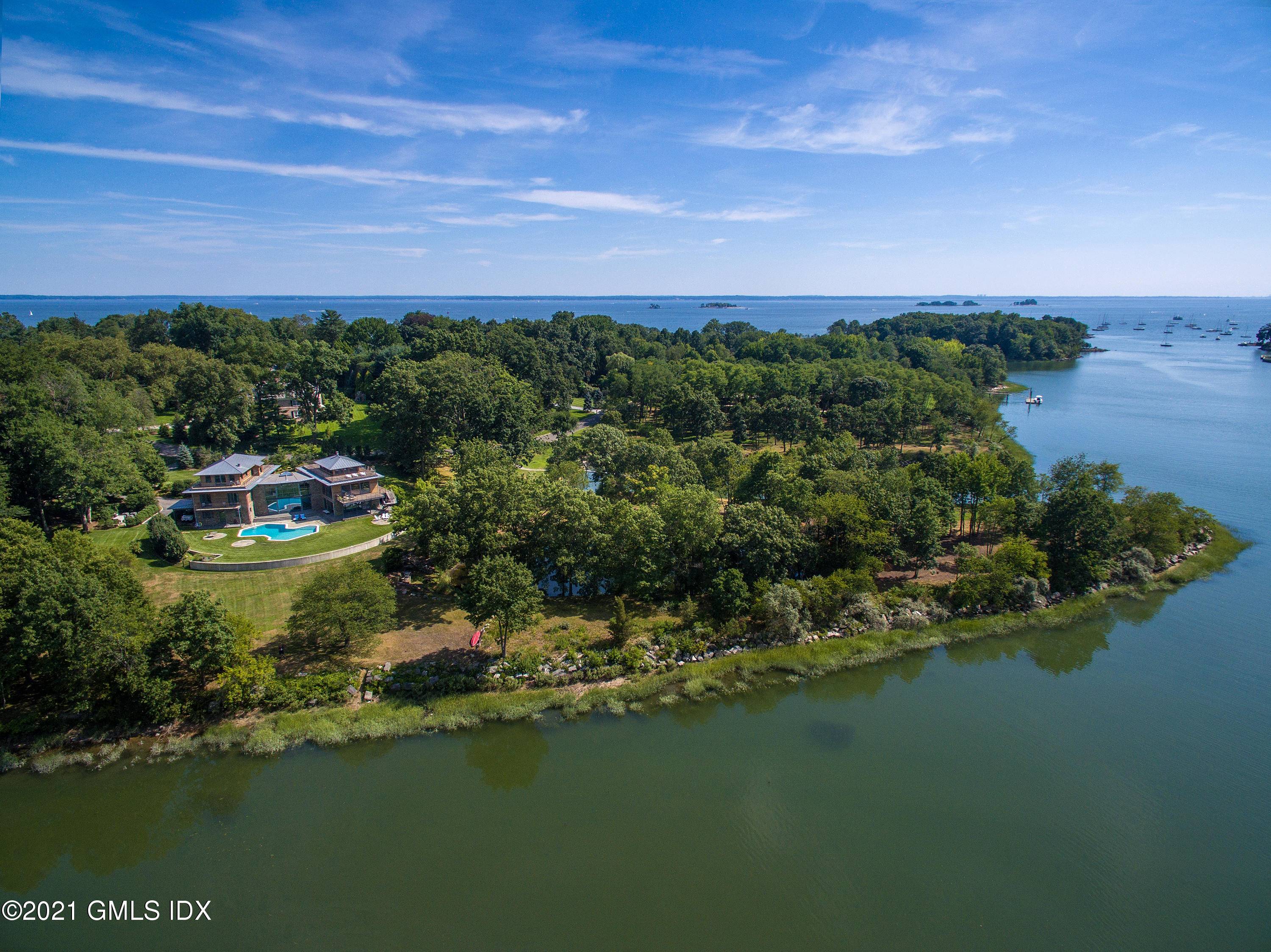 Stunning waterfront home in the exclusive, 24hr guard gated Mead Point association.