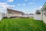Rear view of property featuring a wooden deck and a fenced backyard