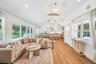 Living room featuring vaulted ceiling, a chandelier, light wood-type flooring, and recessed lighting