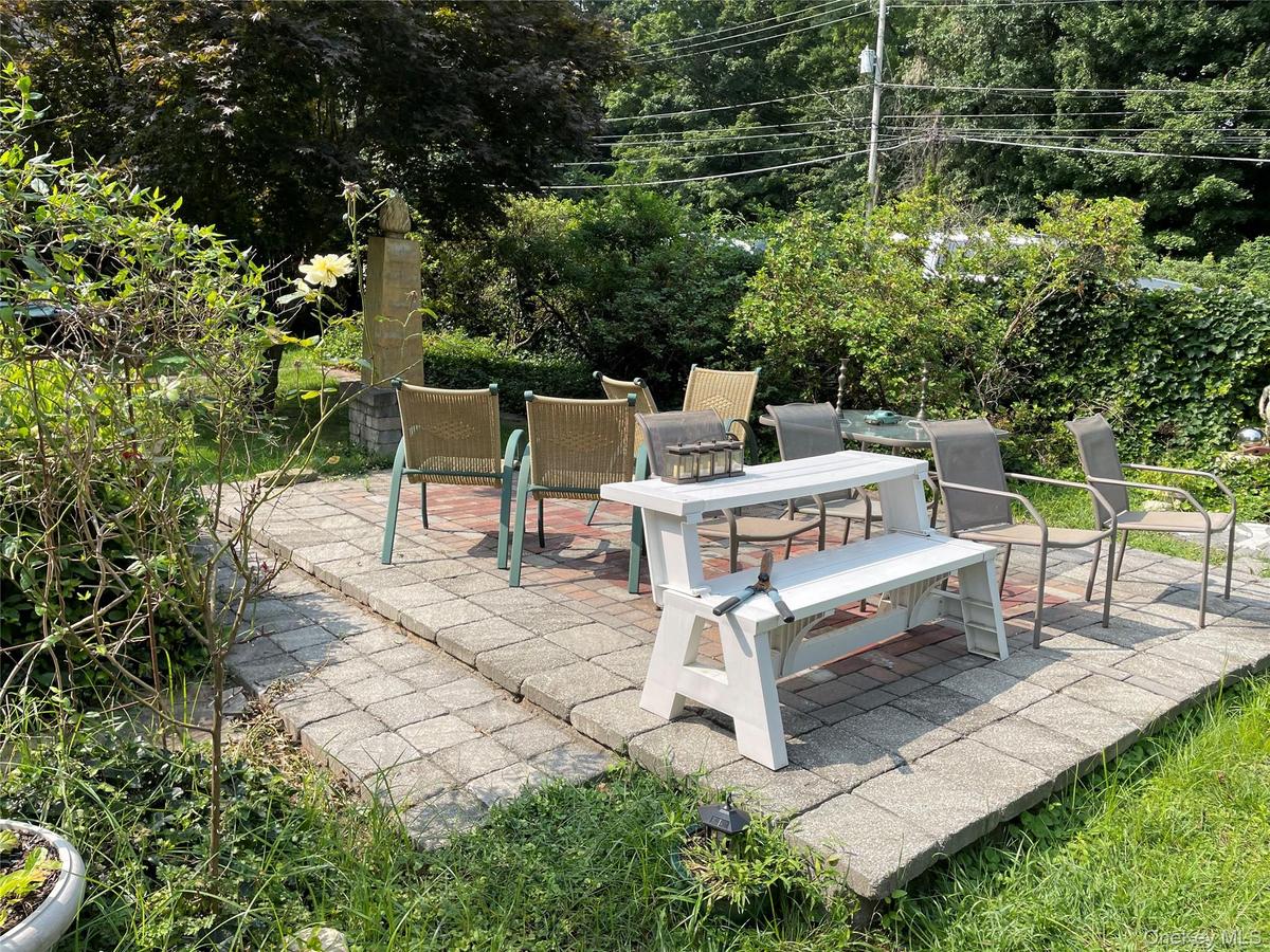 View of patio / terrace featuring view of wooded area