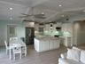 Open living area with a vaulted white wood ceiling and exposed trusses.