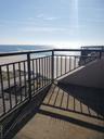 Balcony with view of water and beach
