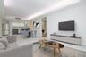 Living area with a tray ceiling, light wood finished floors, and recessed lighting