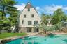 Another perspective of the stunning backyard with sparkling saltwater pool with a view of the large sliding glass doors leading to the recreation room