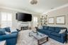 Living room with view of the built in bookcase (has access to water if you wold like a wet bar