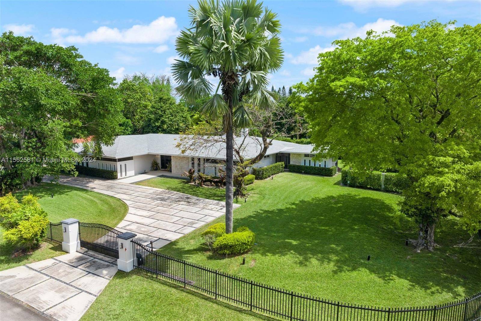 Gated family home on corner acre lot in one of the most sought after neighborhoods of South Florida.