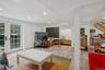 Living area with wood finished floors, stairway, french doors, recessed lighting, and crown molding