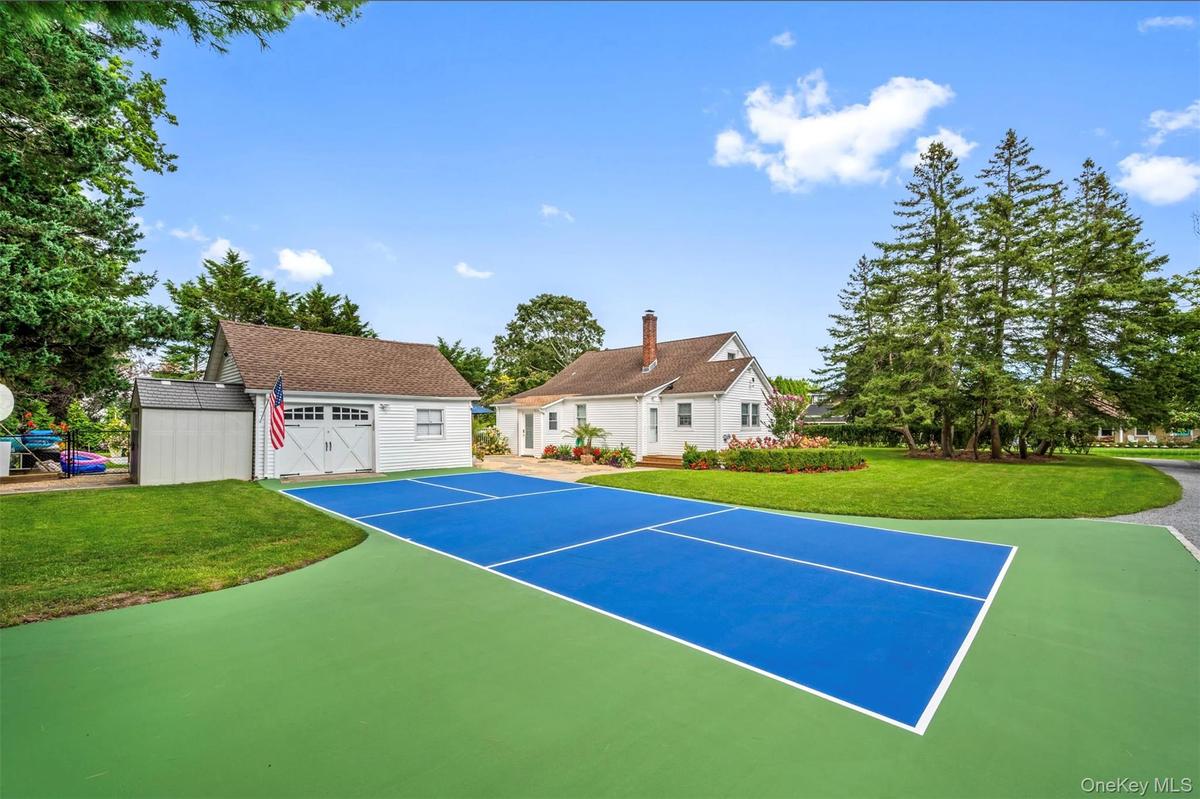 View of sport court with an outbuilding and a lawn