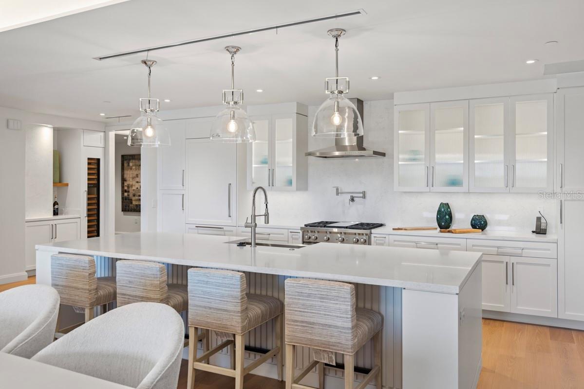 Custom frameless contemporary wood cabinetry with full-extension drawer glides, soft-close drawer and doors, complemented by under-cabinet lighting.