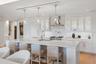 Custom frameless contemporary wood cabinetry with full-extension drawer glides, soft-close drawer and doors, complemented by under-cabinet lighting.