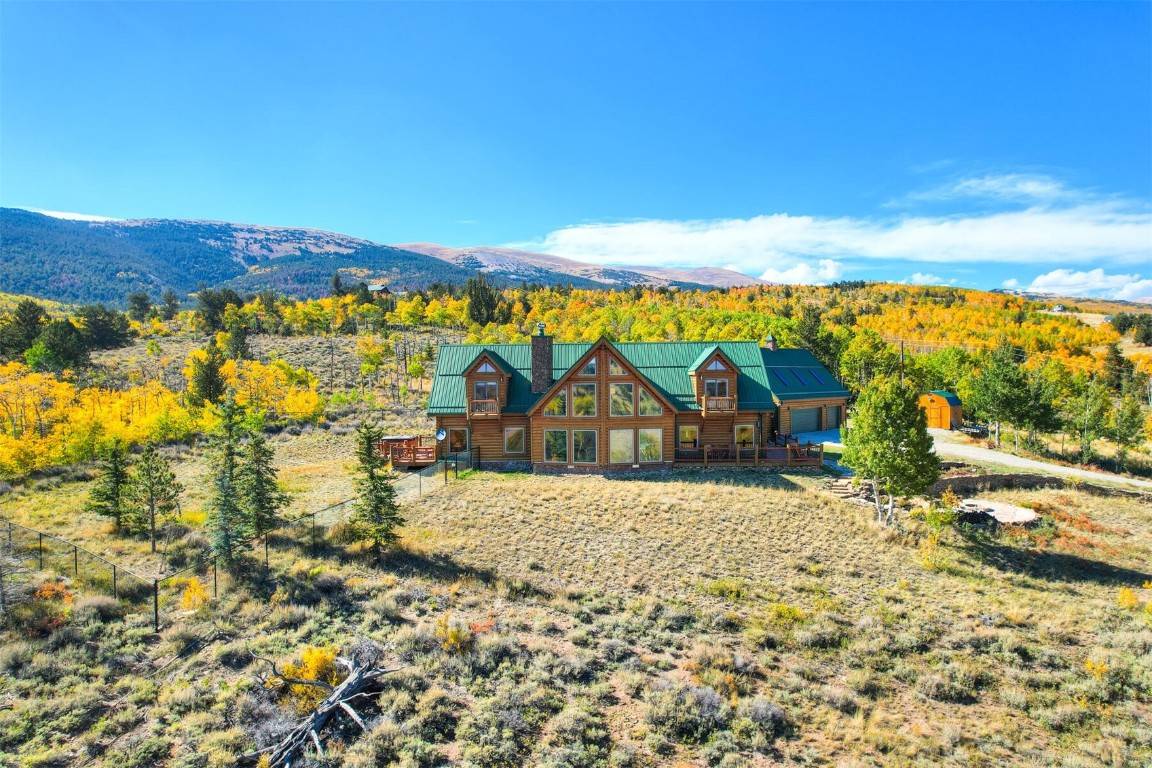 Step through the welcoming gate and follow the winding road, flanked by majestic Aspen trees, leading you to an enchanting log home nestled amidst breathtaking views of Buffalo Peak, Pikes ...