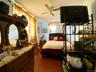 Bedroom with dark wood-type flooring and ceiling fan
