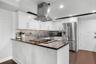 Kitchen has stainless steel appliances and efficient work spaces
