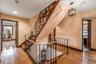Stairs with wood-type flooring and a chandelier